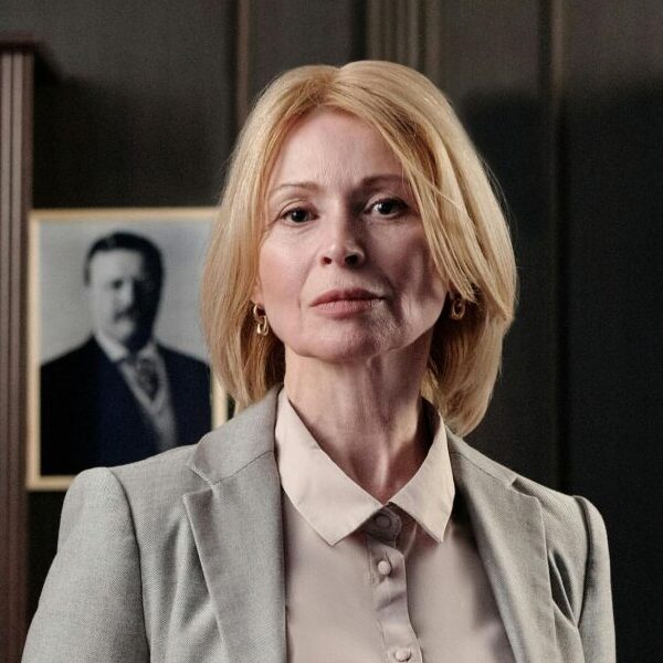 Portrait of a confident businesswoman standing in an elegant office setting.